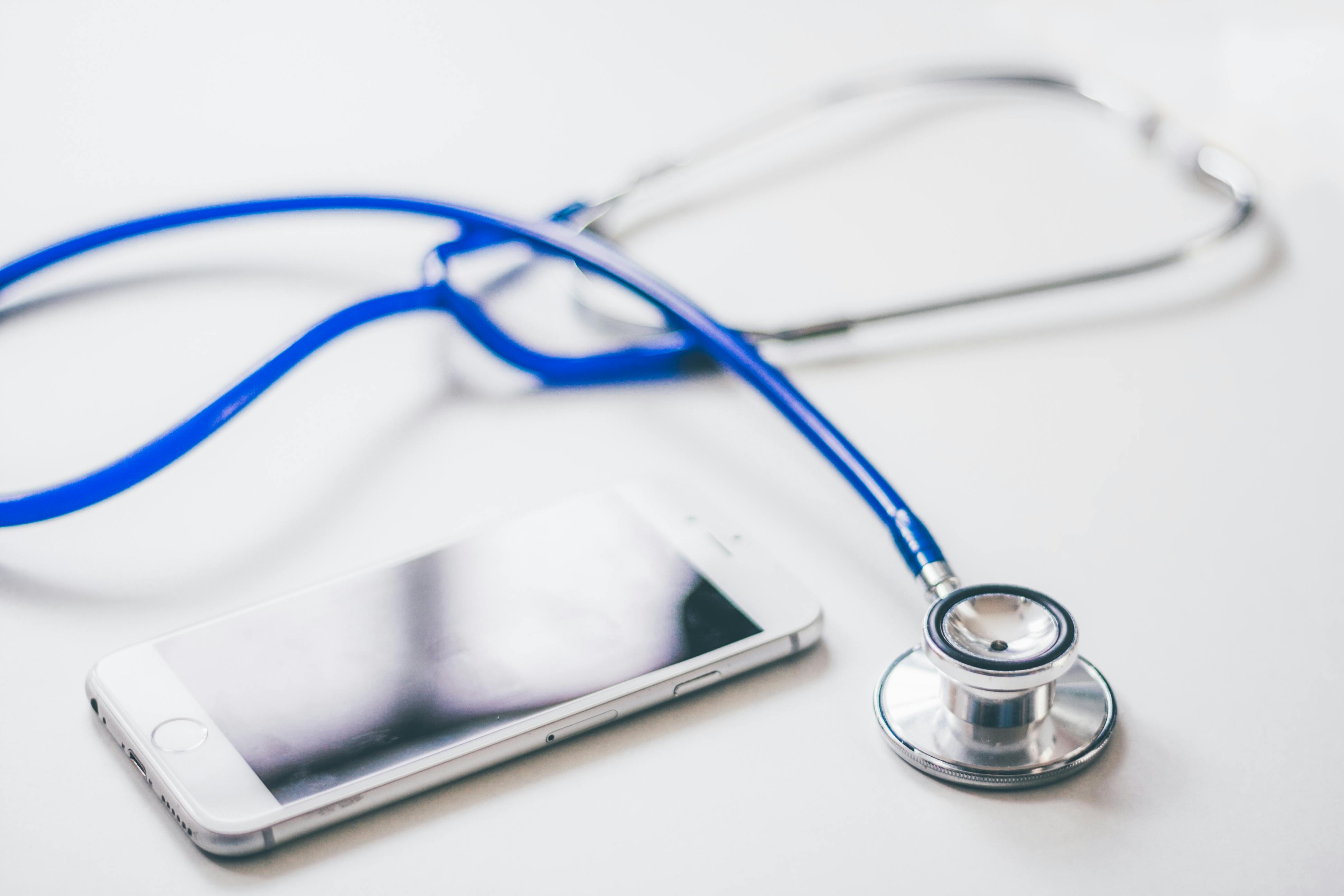 A phone and a stethoscope lying on the desk